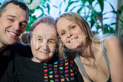 Happy couple posing with grandma