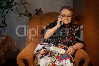 Elderly woman talking on the home phone