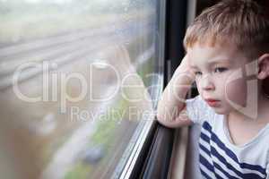 Boy looking out the window of train