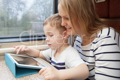 Mother and her young son on a train
