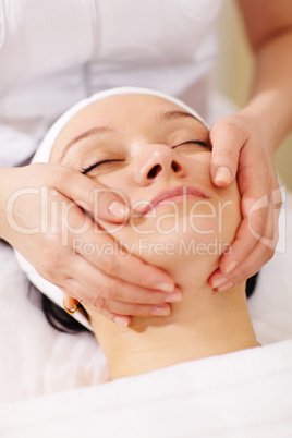 Woman in the beauty spa getting a facial massage