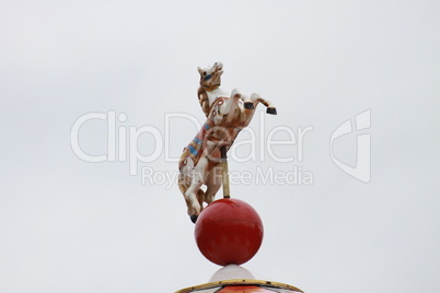 Figure of a white horse on the old carousel