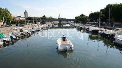 The water channel with parked motor boats, Rimini, Italy