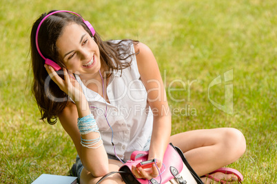 Summer student girl listen music sitting grass