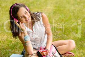 Summer student girl listen music sitting grass