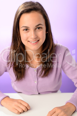 Student girl sitting behind desk purple portrait