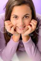 Teenage girl smiling on purple close-up portrait
