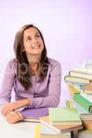 Smiling student girl looking up purple background