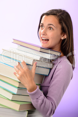 Shocked student girl carry stack of books