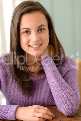 Teenage girl at home wear purple jumper