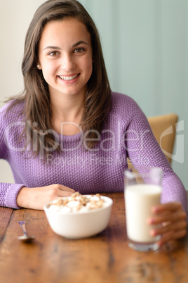 Happy teenage girl enjoy healthy cereal breakfast