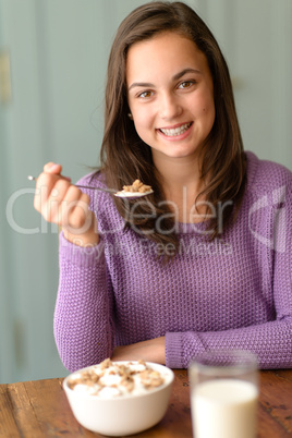 Teenage girl enjoy healthy cereal breakfast smile
