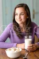 Thinking teenage girl enjoy healthy breakfast