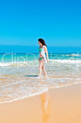 Girl walks along the sea