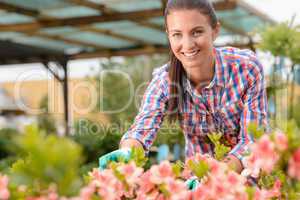 Smiling florist working in garden center