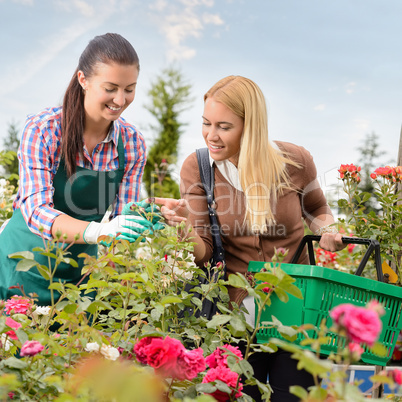 Garden center worker give advice woman customer