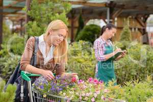 Woman shopping for flowers in garden center