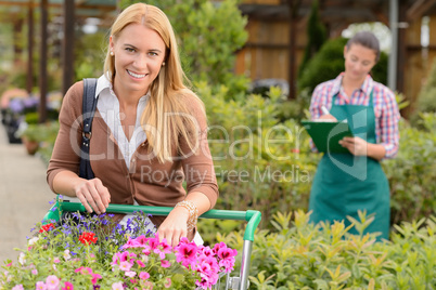 Young woman shopping  flowers in garden center