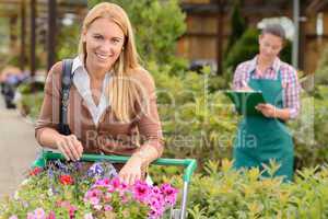 Young woman shopping  flowers in garden center