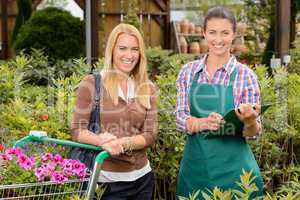 Customer and worker in garden center smiling