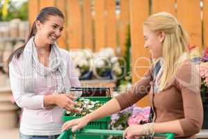 Two smiling woman shopping plants garden center