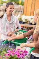 Two women shopping in garden center talking