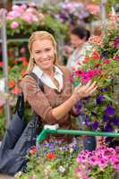 Woman shopping for colorful flowers garden center