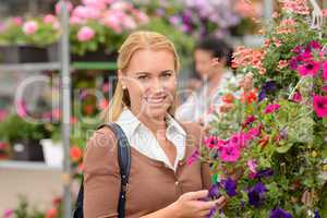 Smiling customer with colorful flowers garden center