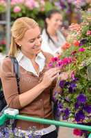Woman in garden center looking at flowers