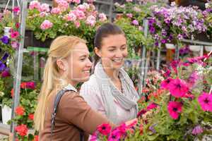 Two customer woman choose flowers garden center