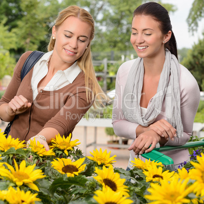 Two woman shopping for sunflowers garden center