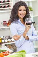 Woman Drinking Red Wine in Home Kitchen