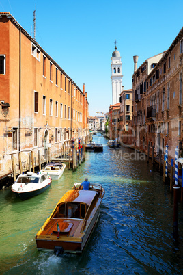 The water taxi with tourists is on water channel, Venice, Italy