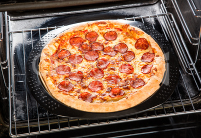 Pepperoni pizza in the oven.