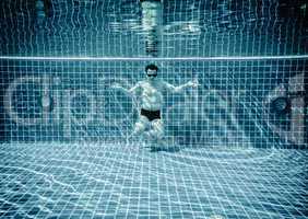 Persons lies under water in a swimming pool