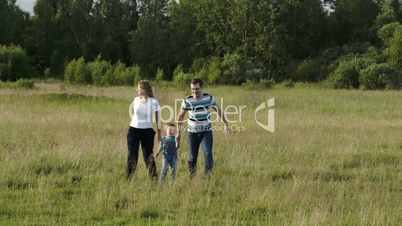 Family of three having active rest together outdoor