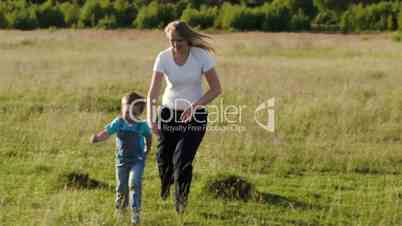 Young mother playing with her son outdoor