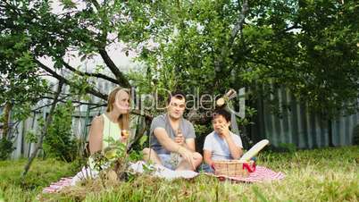 Parents with their son having picnic in the courtyard