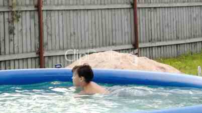 Boy swimming in inflatable pool