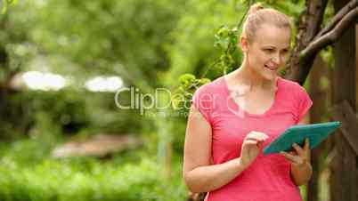 Woman working with tablet PC outdoor
