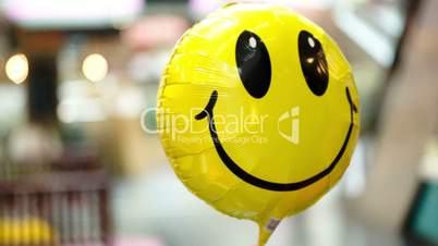 Smiling balloon floating in the air