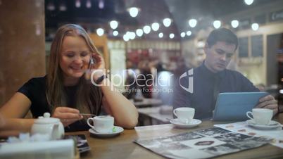 Young people in a cafe with phone and Tablet PC