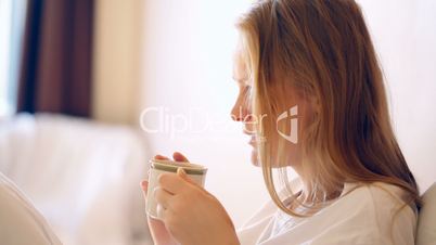 Woman having a cup of hot coffee in the morning