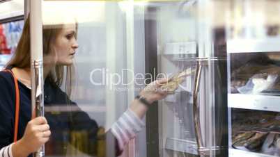 Woman choosing products in the frozen section