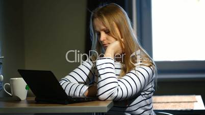 Woman working with laptop at home