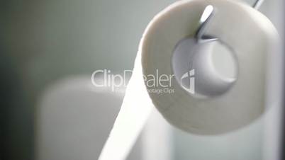 Macro shot of unrolling a toilet paper