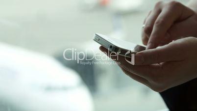 Close-up shot of female hands typing sms on smartphone