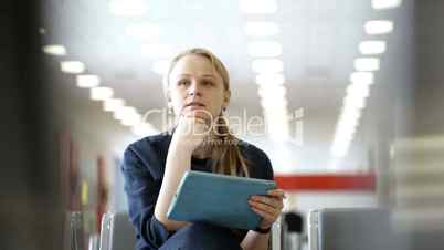 Young woman with pad sitting in the waiting room