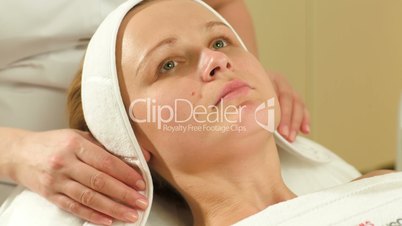 Woman being prepared for facial spa procedures