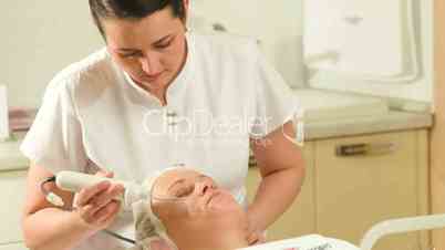 Woman getting anti-aging therapy at beauty treatment salon